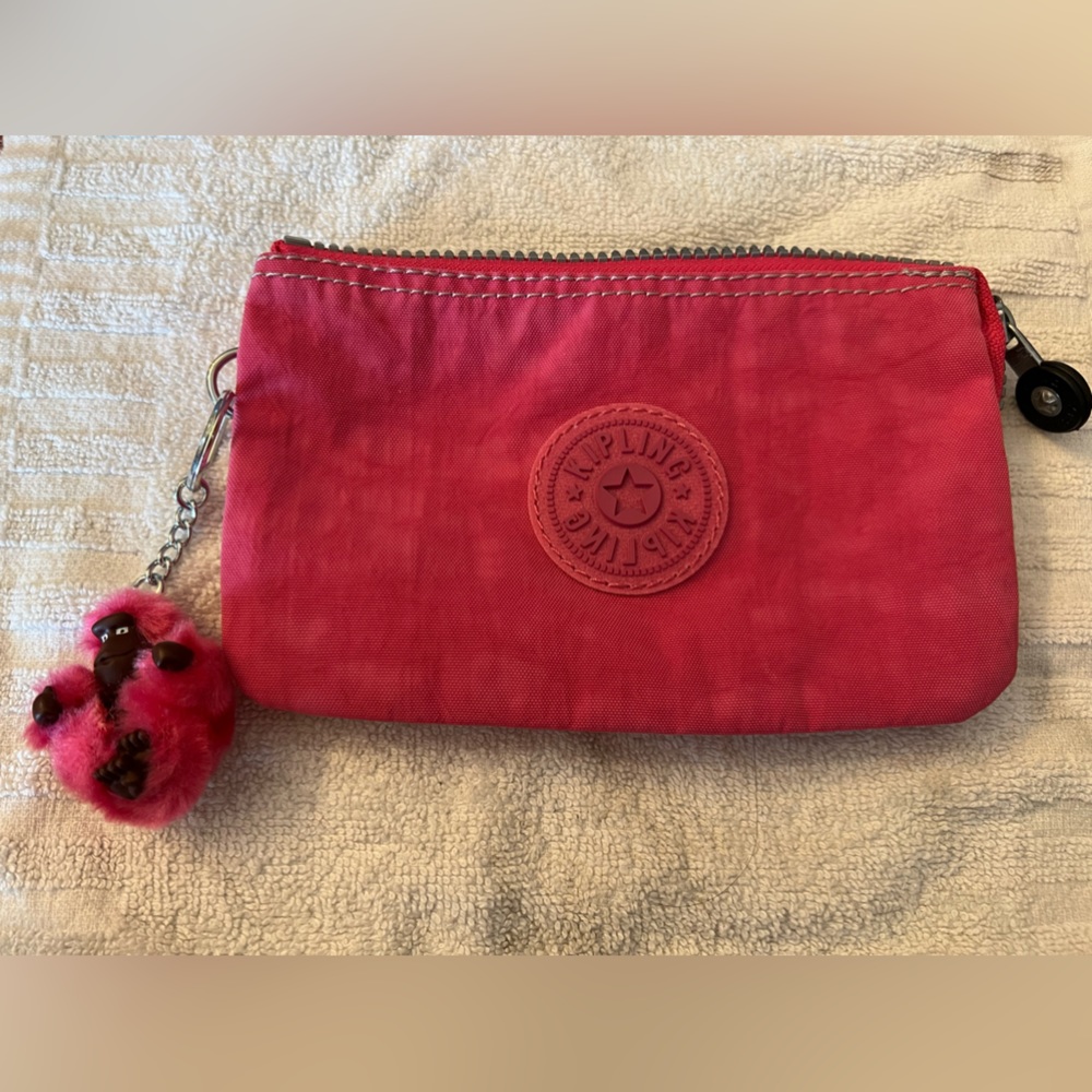 Kipling pink wristlet.